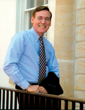President Pro Tempore of the Senate Glenn F. McConnell, smiling, leaning against an outdoor railing.